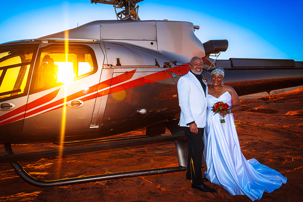 Couple exchanging vows on private red rock peak Valley of Fire helicopter wedding