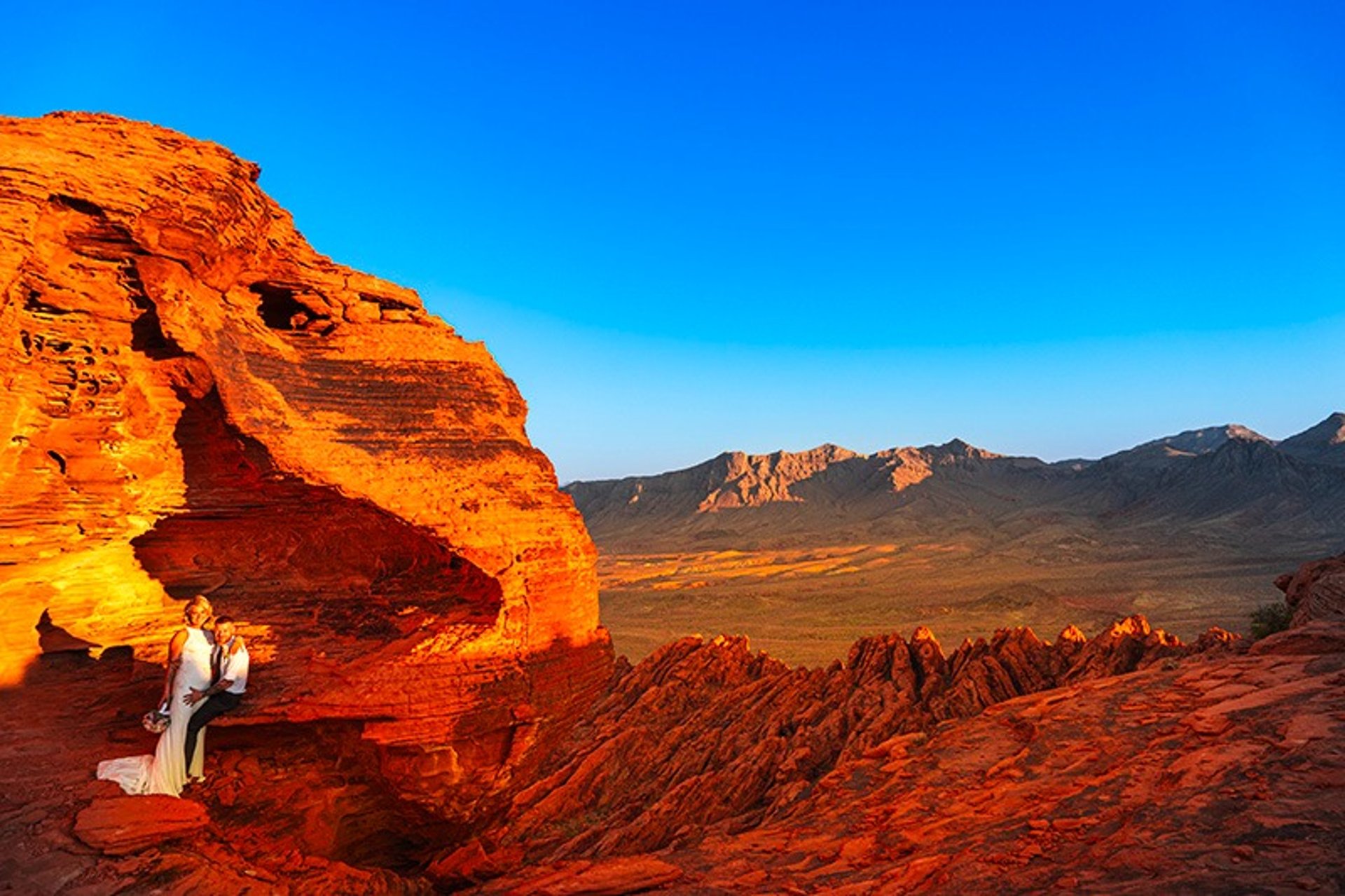 Las Vegas helicopter wedding couple on red rock formation Valley of Fire desert ceremony