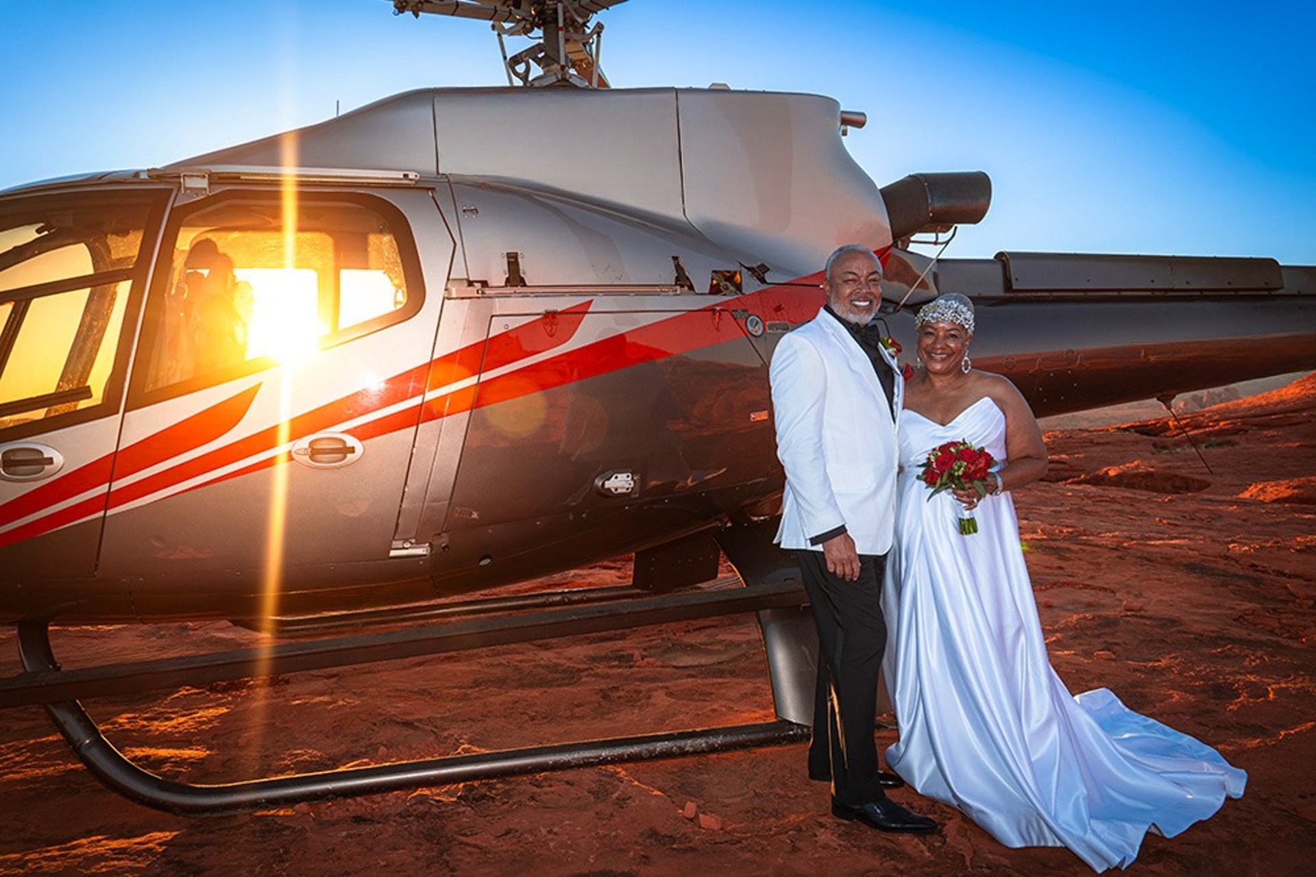 Helicopter wedding couple on red rock plateau at Valley of Fire Nevada at sunset