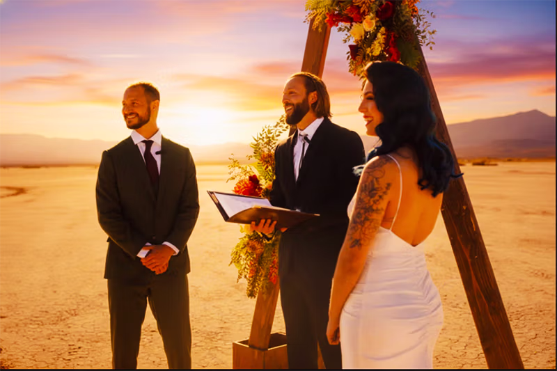 Couple exchanging vows under styled arch at Eldorado Dry Lakebed Las Vegas