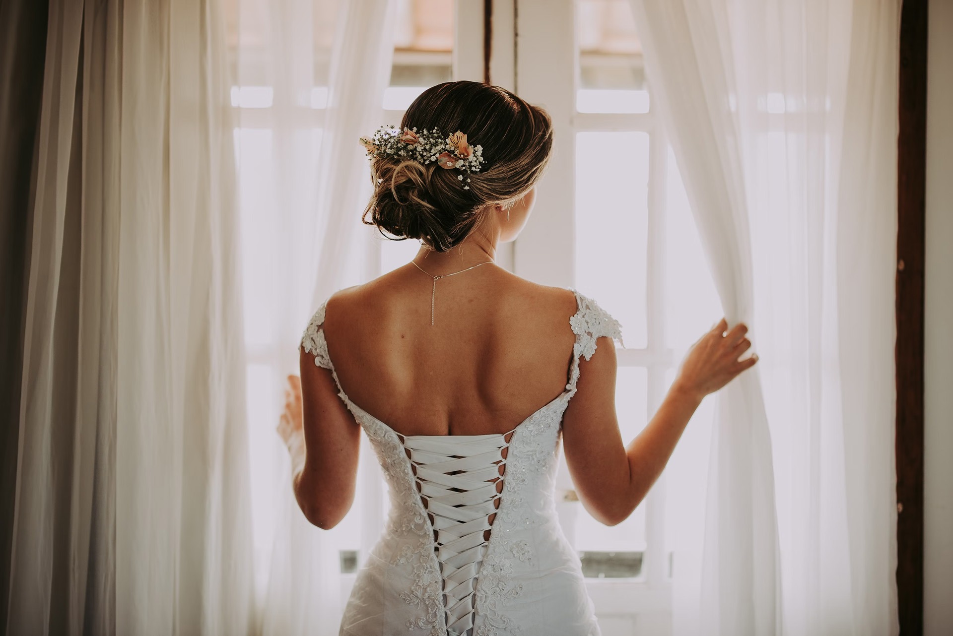 Bride at hotel room window in Las Vegas — Sign & Go wedding ceremony brought to your room by LVWC officiant