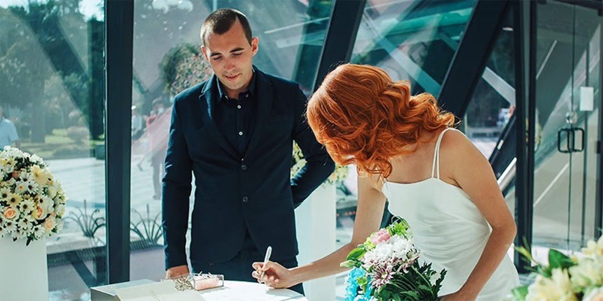 Bride and groom signing marriage license Las Vegas hotel room ceremony