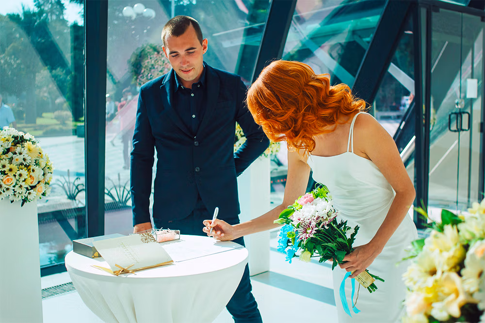 Couple signing Nevada marriage license Las Vegas hotel room ceremony