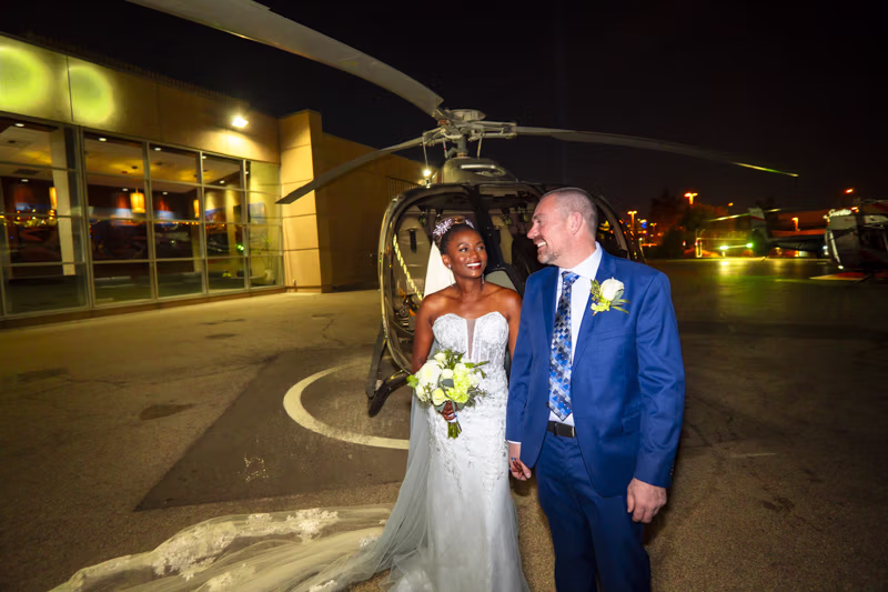 Couple in front of helicopter before Las Vegas Strip wedding flight