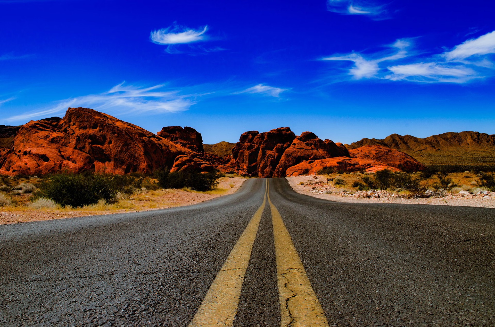 Scenic desert road to Valley of Fire State Park at golden hour