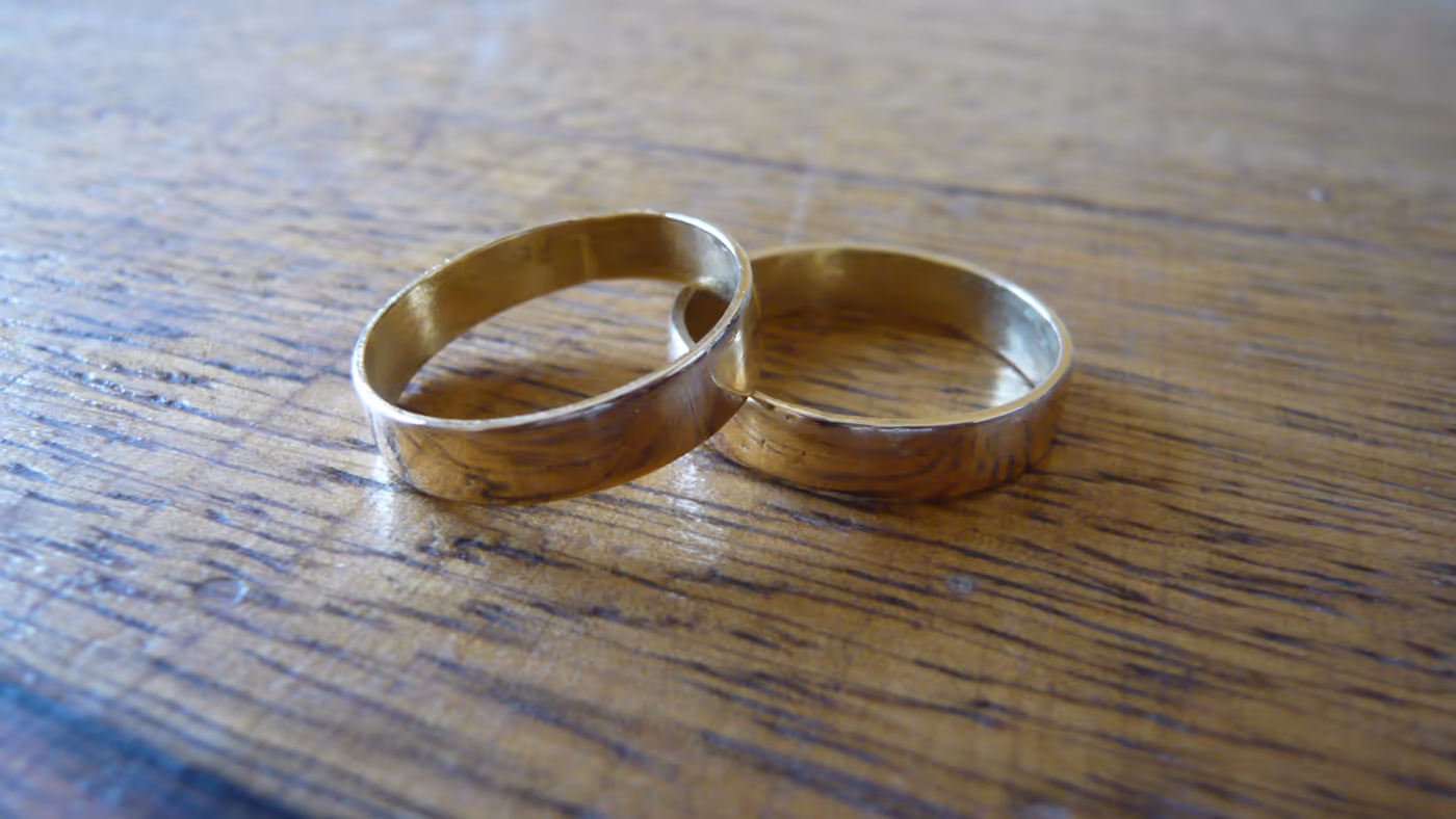 Two gold wedding bands side by side, representing a couple's combined life path number — LVWC.com